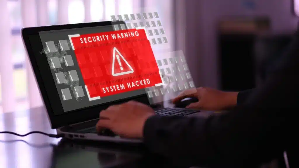 Virtual security warning system hacked alert on laptop screen.