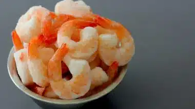 Close up on a Bowl Full of Frozen Cooked Shrimp.