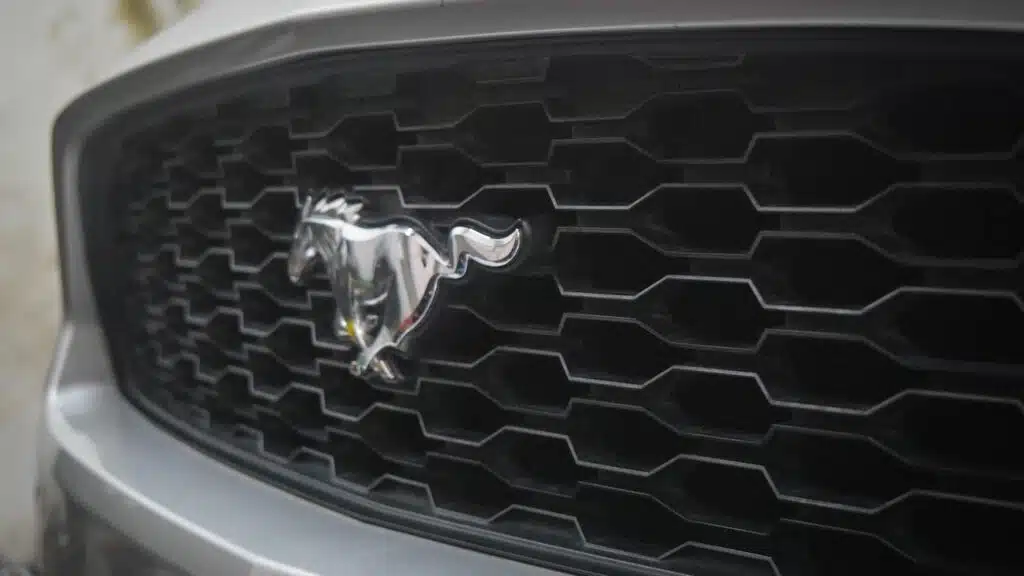 Ford Mustang logo badge on the front grille of a Ford Mustang coupe