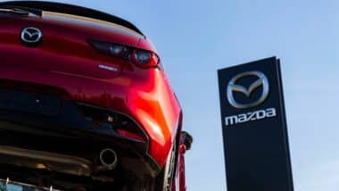 Mazda Motor Corporation logo on car in front of dealership building on April 12, 2025