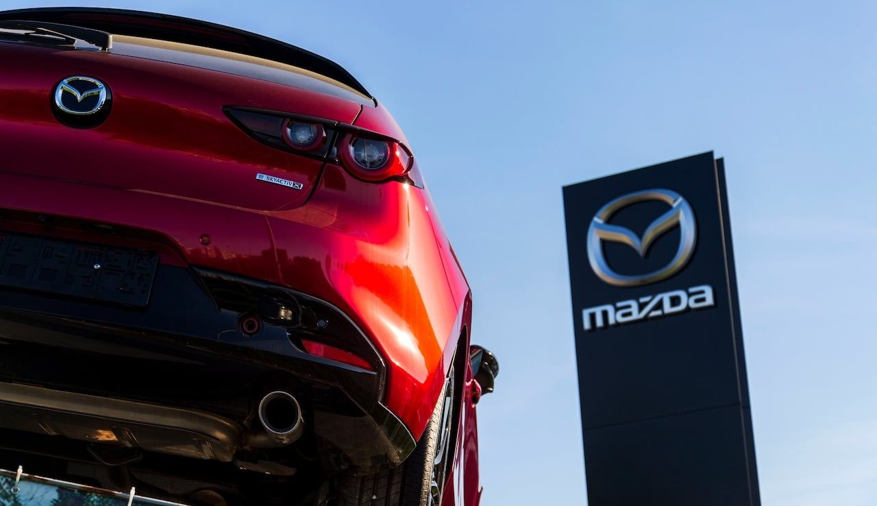 Mazda Motor Corporation logo on car in front of dealership building on April 12, 2025