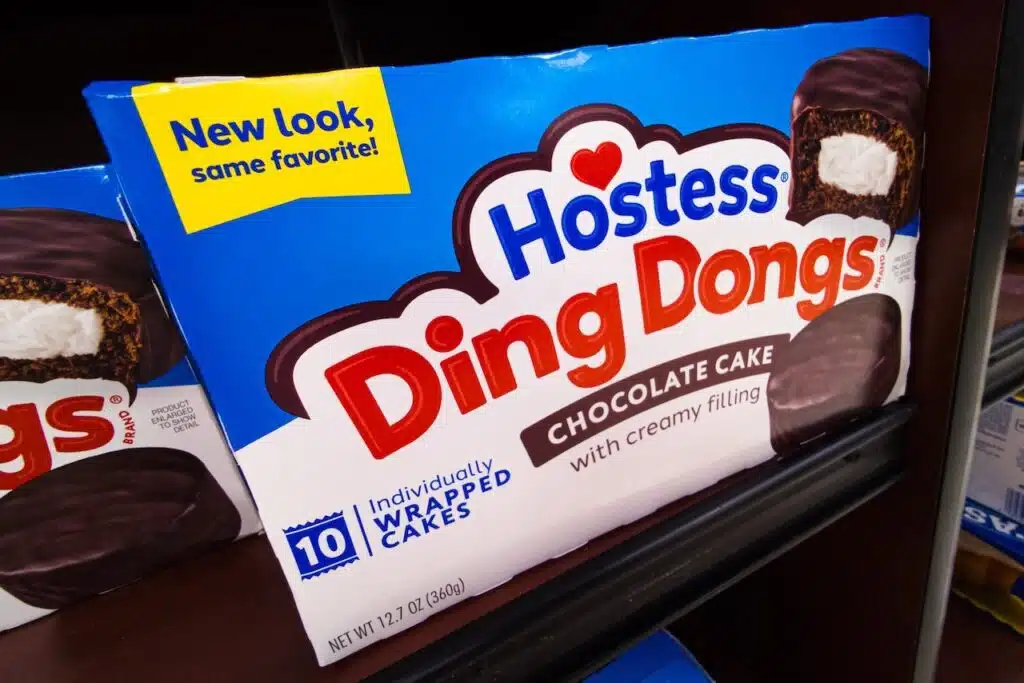 Packages of Hostess Ding Dongs Chocolate Cake Brand Baked Goods Treats Snacks Donuts Logo Display Boxes on Shelf