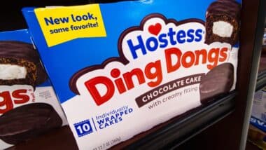 Packages of Hostess Ding Dongs Chocolate Cake Brand Baked Goods Treats Snacks Donuts Logo Display Boxes on Shelf