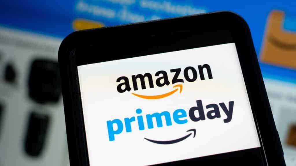 Amazon Prime Day Week Logo On Smartphone And Laptop Screens With Shopping Deals Website In Background