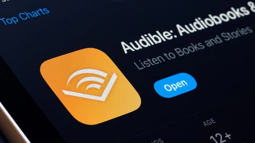 Audible App Store listing on iPhone highlights audiobooks and podcast listening. S