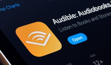 Audible App Store listing on iPhone highlights audiobooks and podcast listening. S