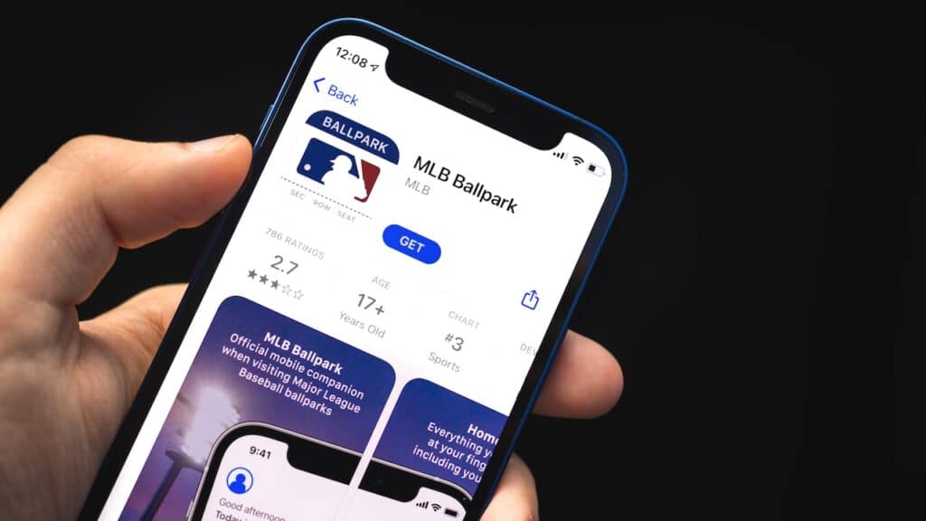 MLB Ballpark app, man hold mobile phone with application on the screen