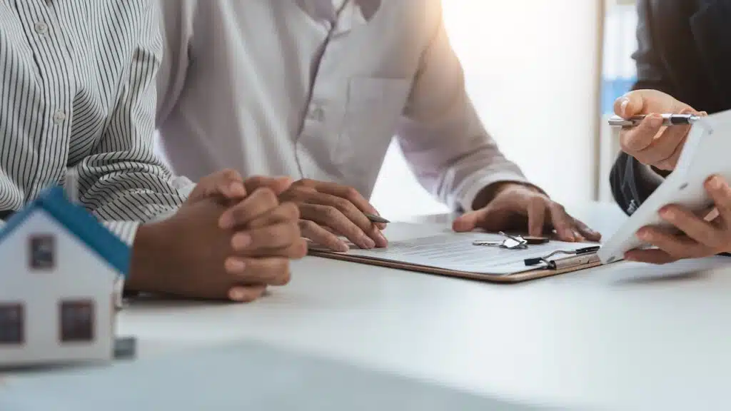 couple signing a contract with mortgage lender