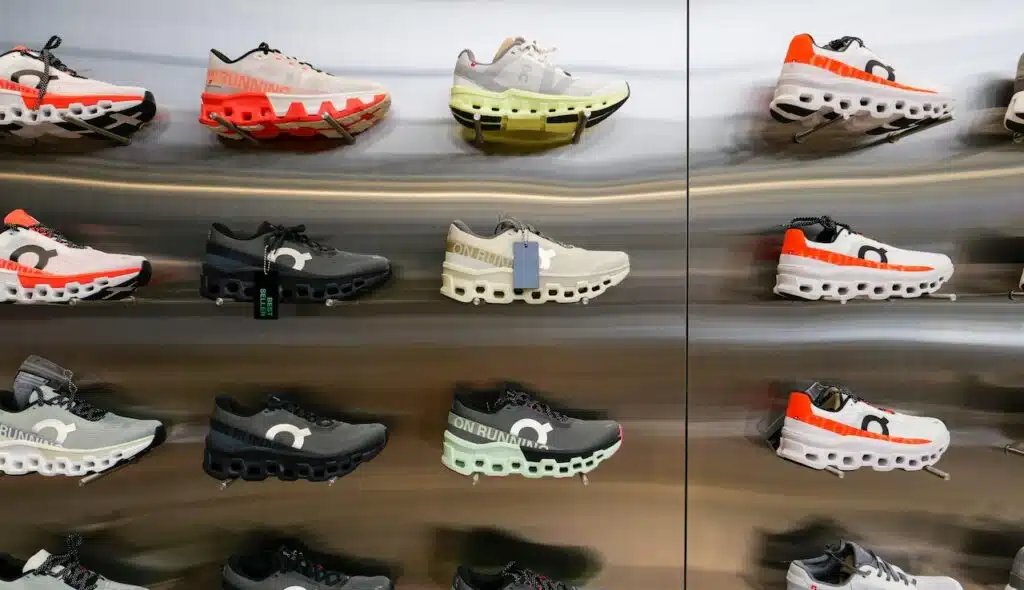 On Cloud Running shoes are against the wall on display at a running shoe specialty store.