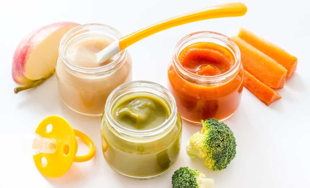 Vegetable and fruits puree for feed babies on white background