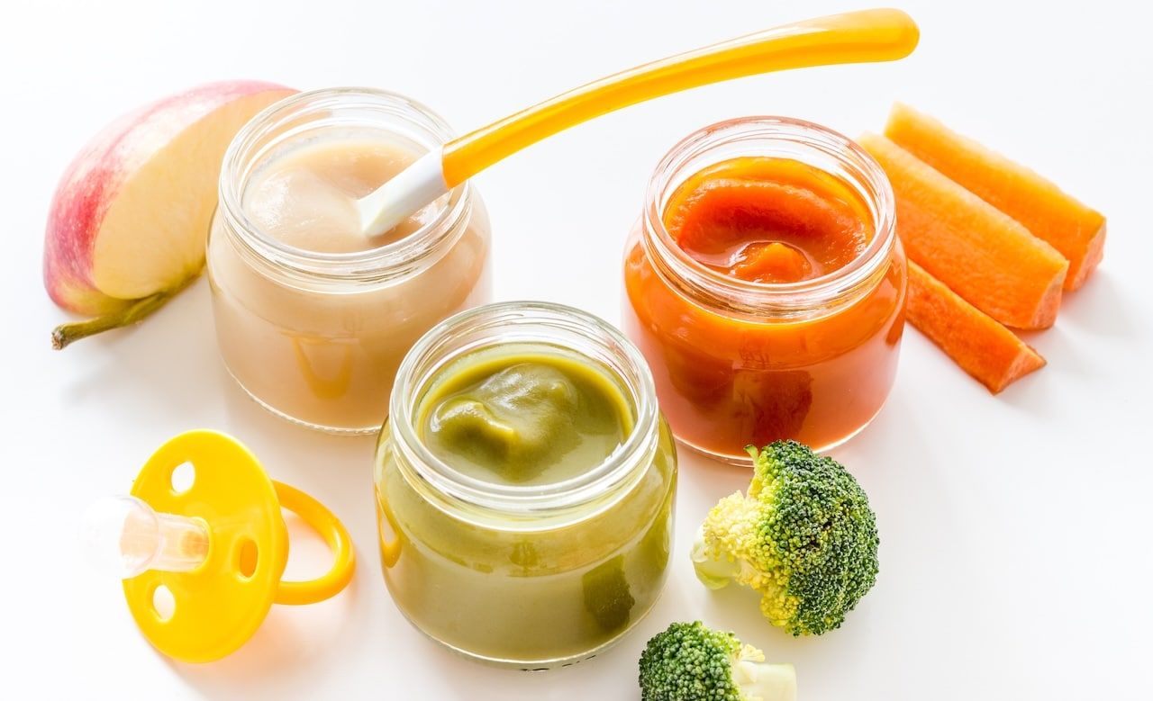 Vegetable and fruits puree for feed babies on white background