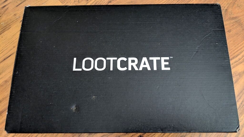 Unopened LootCrate Box on wood floor.