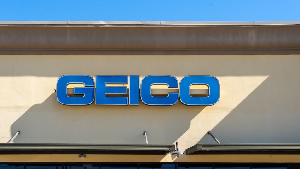 Close up of the GEICO sign on the building at one of its branches.