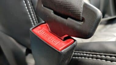 Photo of a seat belt and holder in a car