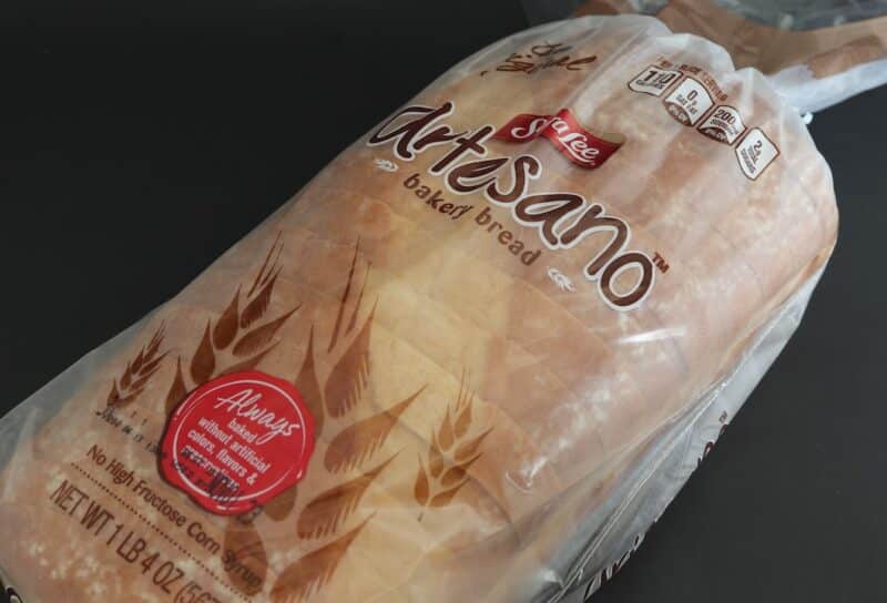 Loaf of Sara Lee artisan bread isolated against dark background.
