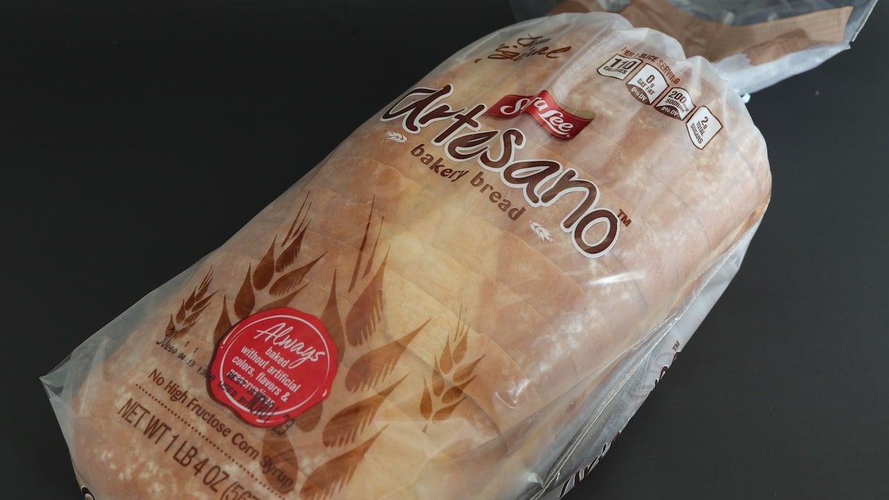 Loaf of Sara Lee artisan bread isolated against dark background.