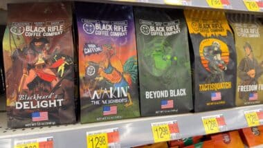 Bags of Black Rifle Coffee Company ground beans on store shelf.