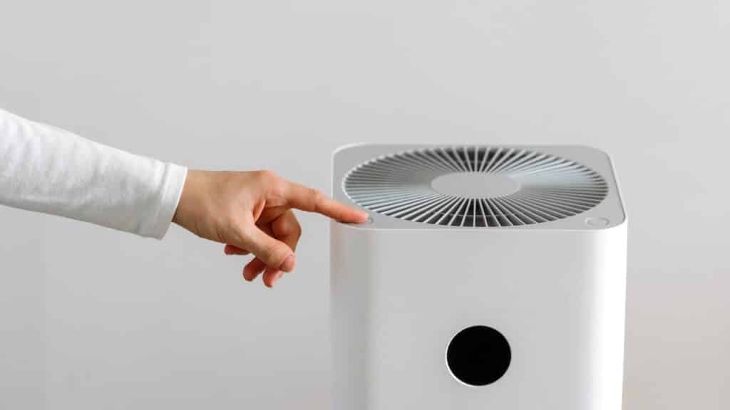 hand turning on air purifier