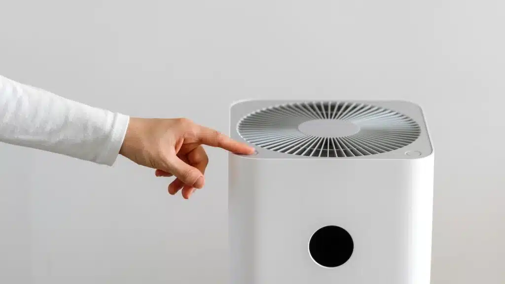 hand turning on air purifier