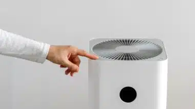 hand turning on air purifier