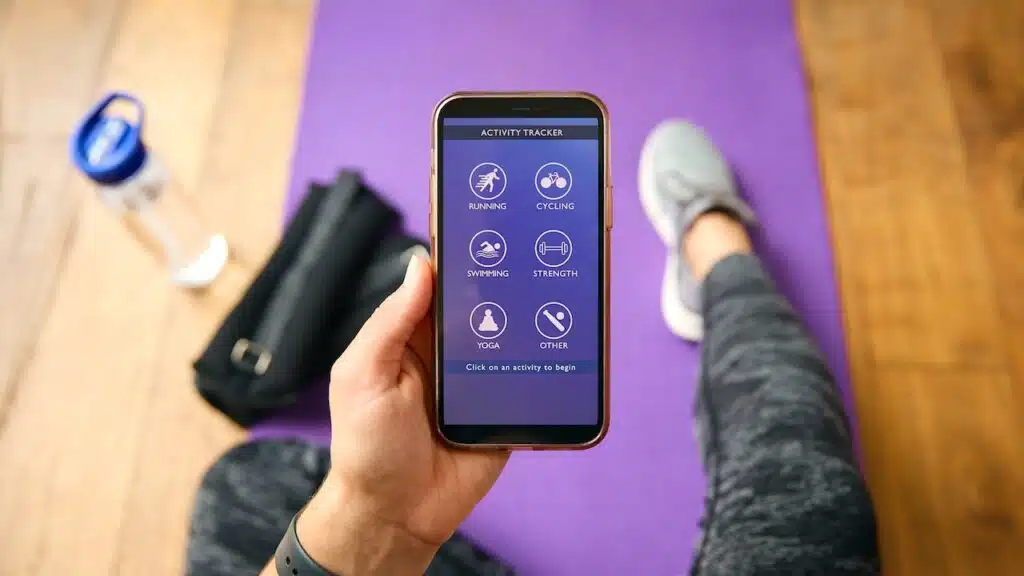 Close Up Of Woman With Smart Watch About To Exercise Looking At Activity Tracker On Mobile Phone