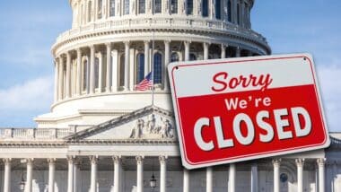 The US Capitol with a closed sign hanging from the dome.
