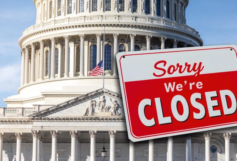 The US Capitol with a closed sign hanging from the dome.