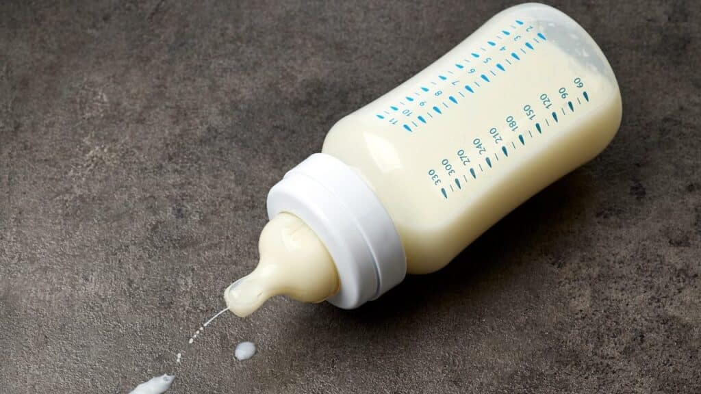 Baby milk bottle on dark grey table