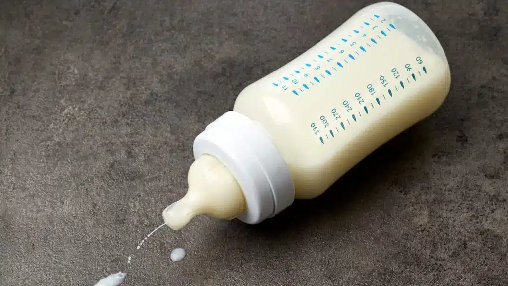 Baby milk bottle on dark grey table
