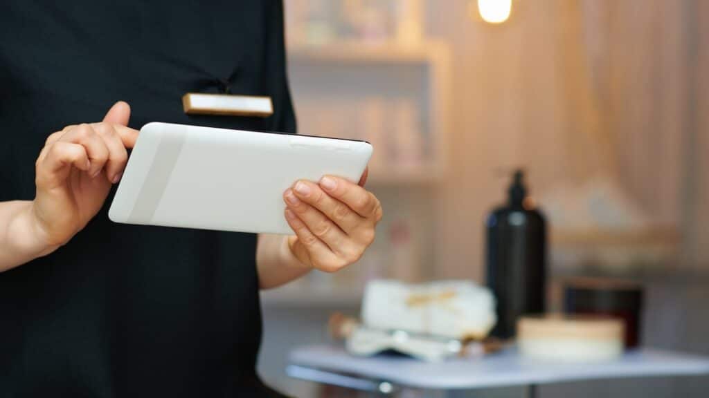 Closeup on female employee in modern clinic using tablet PC.