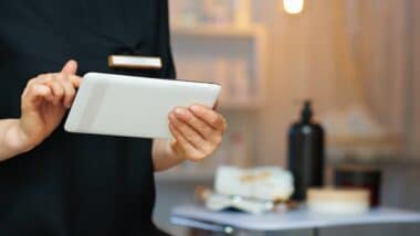 Closeup on female employee in modern clinic using tablet PC.
