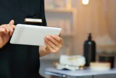 Closeup on female employee in modern clinic using tablet PC.