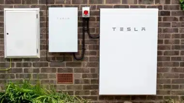 Tesla Powerwall 2 and Backup Gateway 2 installed on a brick house wall