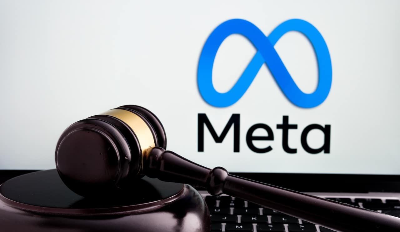 Court gavel placed on laptop with blurred Meta Platforms company logo on the screen.