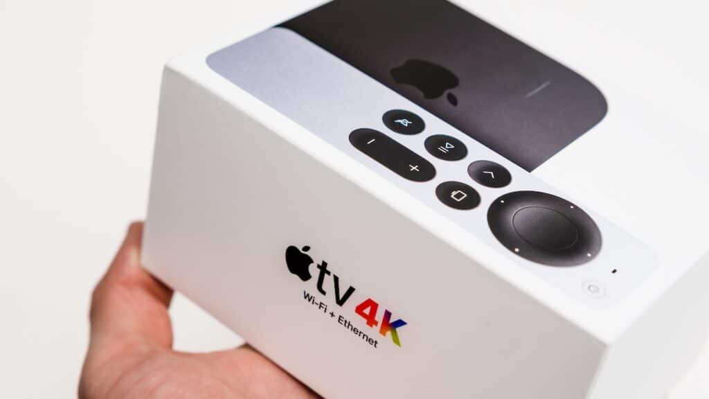 Apple TV 4k Wi fi and Ethernet box in man hand on the white background
