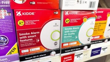 Kidde brand smoke alarms with smart features, hardwired versions on a shelf.