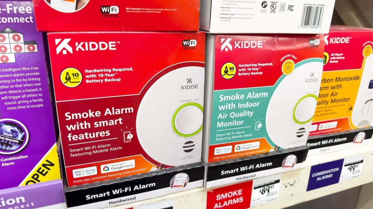 Kidde brand smoke alarms with smart features, hardwired versions on a shelf.