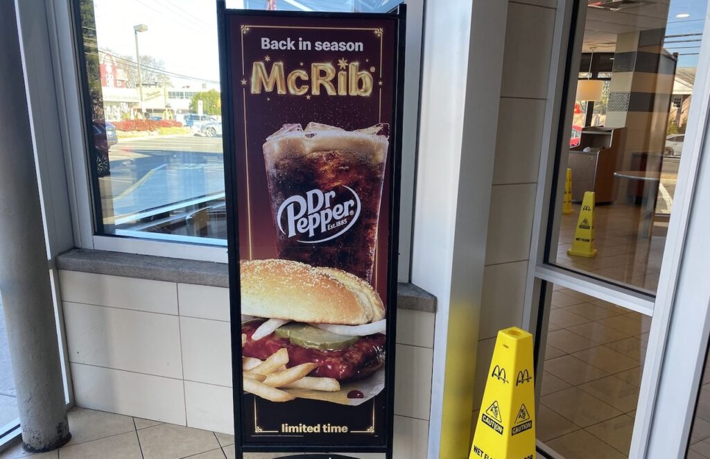 A sign at fast food chain McDonalds for their McRib Sandwich.