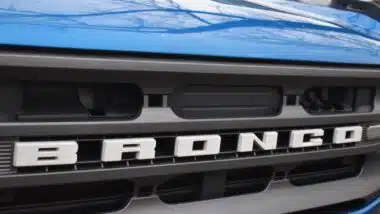 close up shot of the grille of a blue Ford Bronco