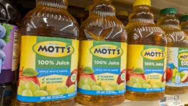 Bottles of Mott's 100% Apple Juice on Store Shelf