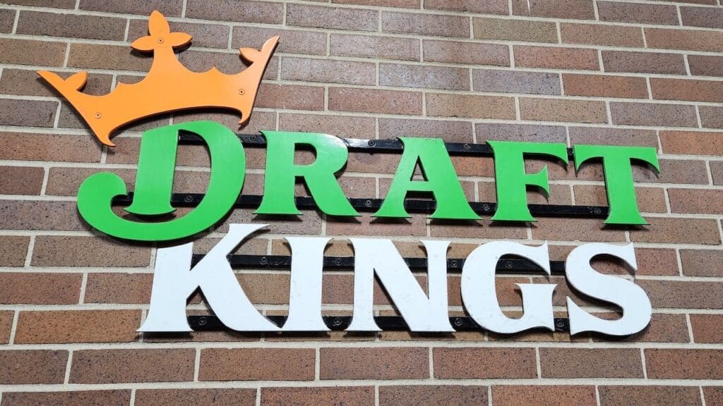 Draft Kings company logo on a red brick wall,