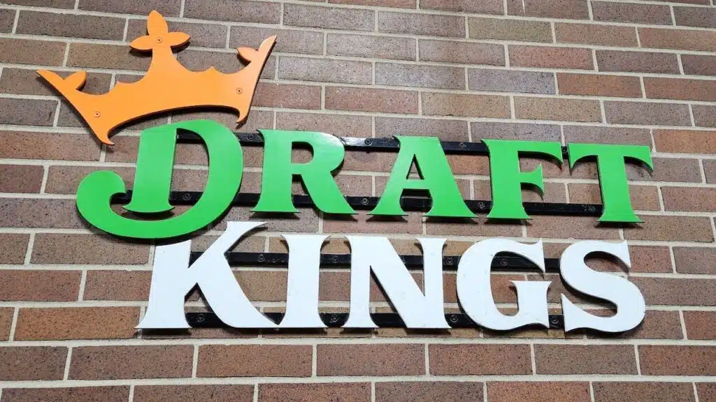Draft Kings company logo on a red brick wall,