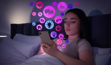 Internet addicted woman using mobile phone instead of sleeping at night.