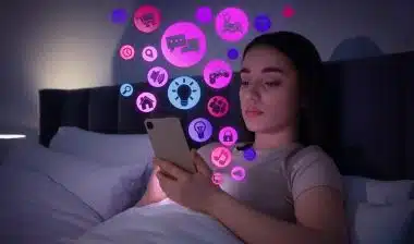 Internet addicted woman using mobile phone instead of sleeping at night.