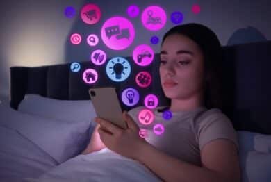 Internet addicted woman using mobile phone instead of sleeping at night.