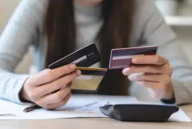 hand of woman sitting, holding credit card, stressed