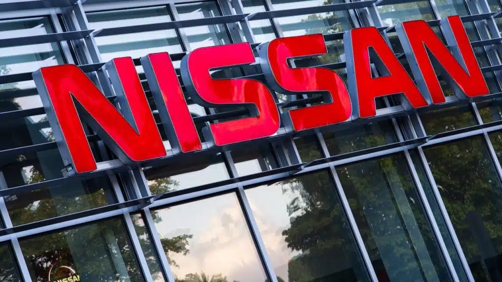 Nissan Motor Corporation Red Brand Logo Emblem Signage At Automotive Dealership Entrance