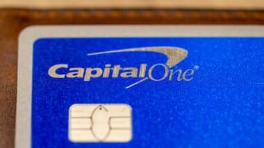 Capital One logo on a silver / blue credit card