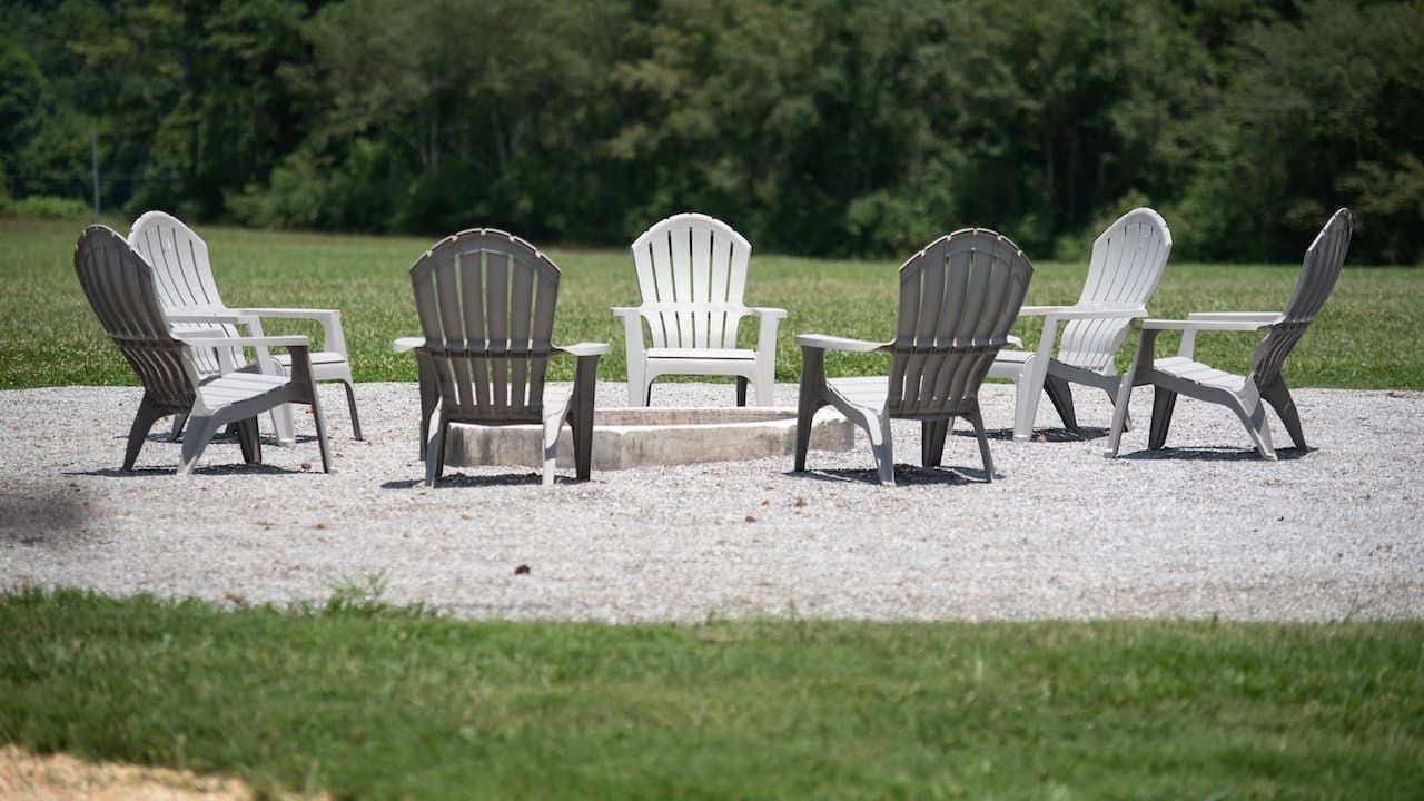 A lot of empty black and white chairs arranged in a circle
