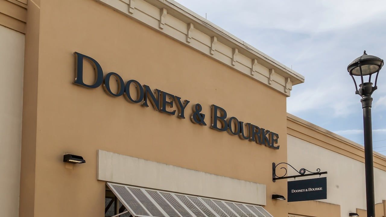 Dooney & Bourke store sign on the wall at Orlando Premium Outlets mall in Florida.